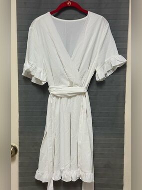 White wrap dress features a deep V-neckline large